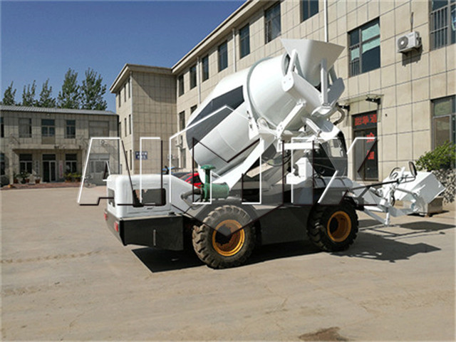 Self loading concrete mixer