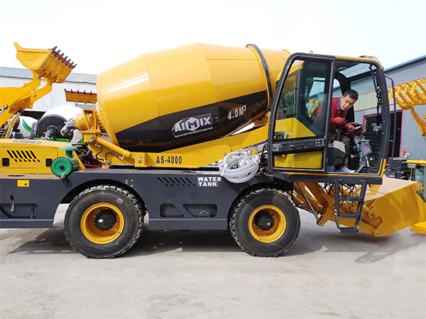 Self loading concrete mixer